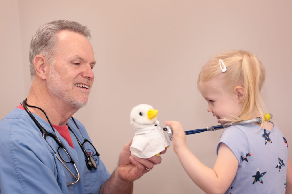 Girl listening to doctor duck's heart
