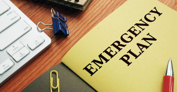 Folder on a desk with "Emergency Plan" on the front